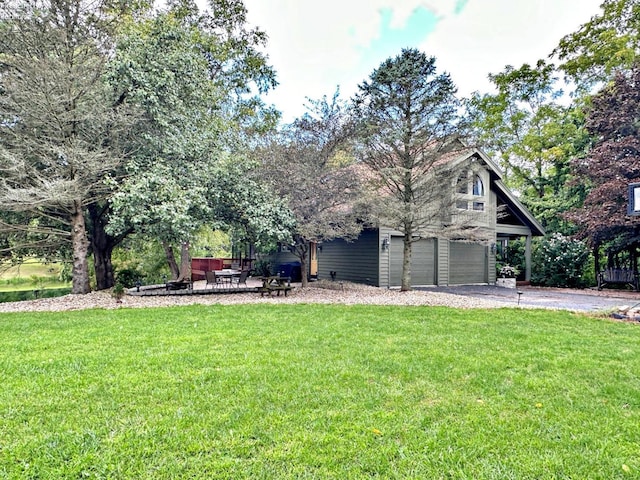 view of front of house featuring a garage and a front lawn