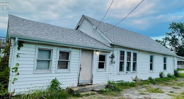 back of property featuring a shingled roof