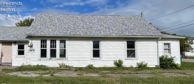 view of home's exterior featuring roof with shingles