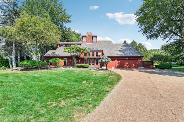 view of front of property with a garage and a front yard