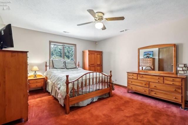 carpeted bedroom with a textured ceiling and ceiling fan