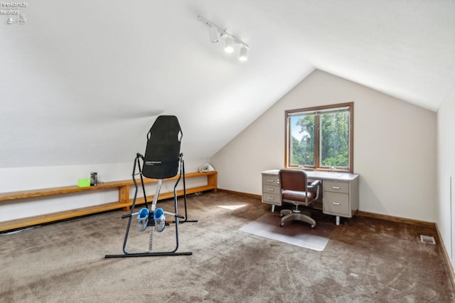 carpeted office space featuring track lighting and vaulted ceiling