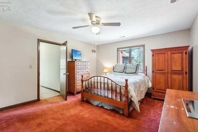 carpeted bedroom featuring a textured ceiling and ceiling fan