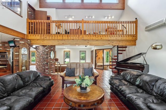 living room featuring dark tile patterned flooring, a wall mounted AC, high vaulted ceiling, and plenty of natural light