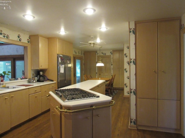 kitchen featuring a center island, ceiling fan, dark hardwood / wood-style floors, appliances with stainless steel finishes, and light brown cabinets