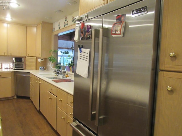 kitchen featuring dark wood-type flooring, appliances with stainless steel finishes, and sink