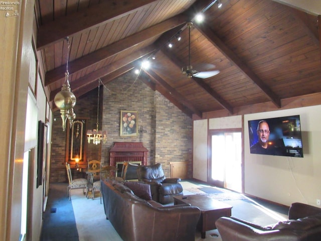 living room with brick wall, beamed ceiling, wooden ceiling, a brick fireplace, and ceiling fan