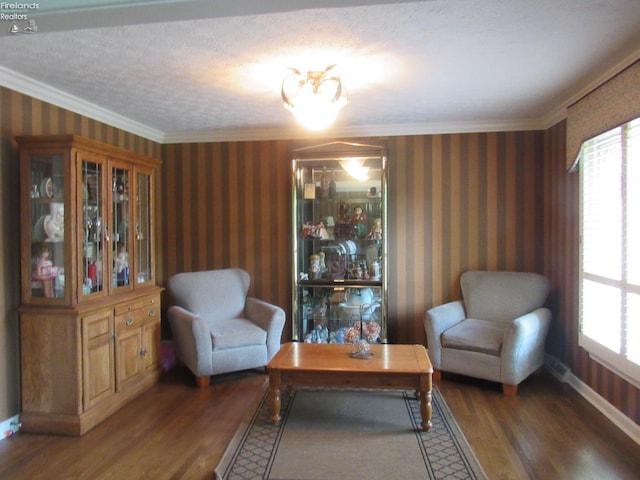 living area with crown molding, a textured ceiling, and dark hardwood / wood-style floors