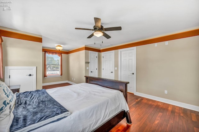 1909 N Nan Ave, Marblehead, OH 43440 - bedroom featuring baseboards, dark wood finished floors, ceiling fan, and two closets