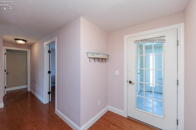 1909 N Nan Ave, Marblehead, OH 43440 - doorway featuring baseboards, wood finished floors, and a textured ceiling