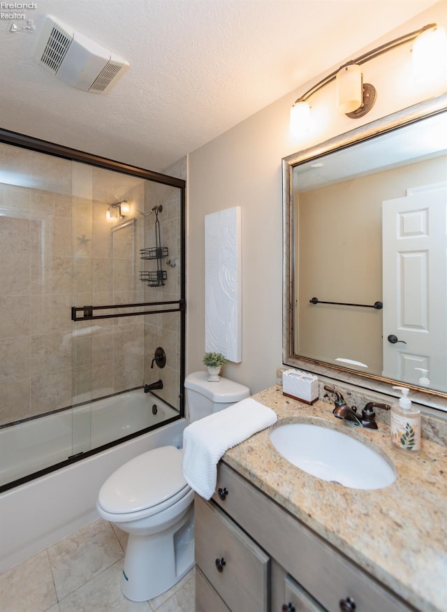 1909 N Nan Ave, Marblehead, OH 43440 - bathroom featuring vanity, toilet, shower / bath combination with glass door, a textured ceiling, and tile patterned floors