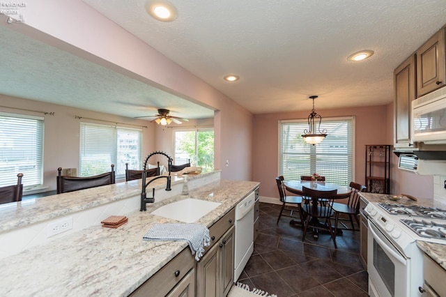 1909 N Nan Ave, Marblehead, OH 43440 - kitchen with a sink, white appliances, dark tile patterned floors, recessed lighting, and decorative light fixtures