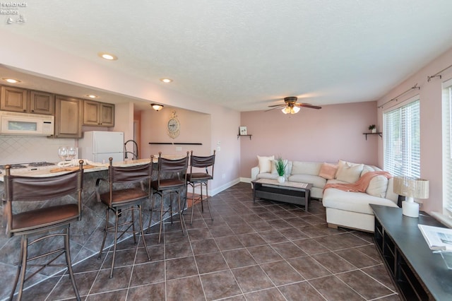 1909 N Nan Ave, Marblehead, OH 43440 - living area featuring a ceiling fan, recessed lighting, dark tile patterned floors, and a textured ceiling