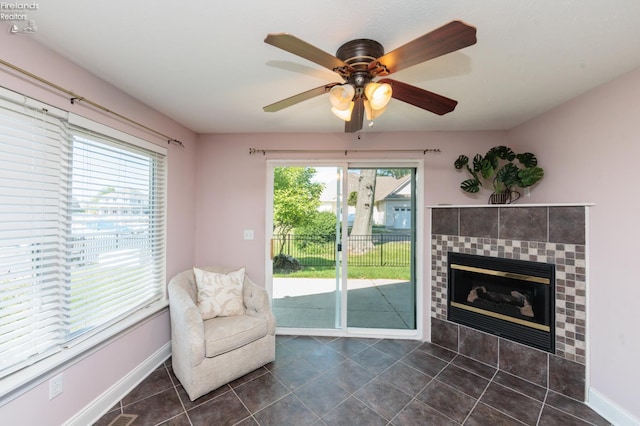 1909 N Nan Ave, Marblehead, OH 43440 - sitting room featuring dark tile patterned flooring, a fireplace, baseboards, and a ceiling fan