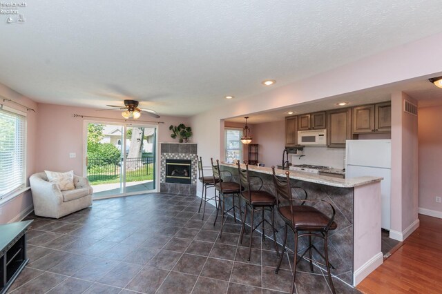 1909 N Nan Ave, Marblehead, OH 43440 - kitchen featuring white appliances, a kitchen bar, open floor plan, a ceiling fan, and recessed lighting