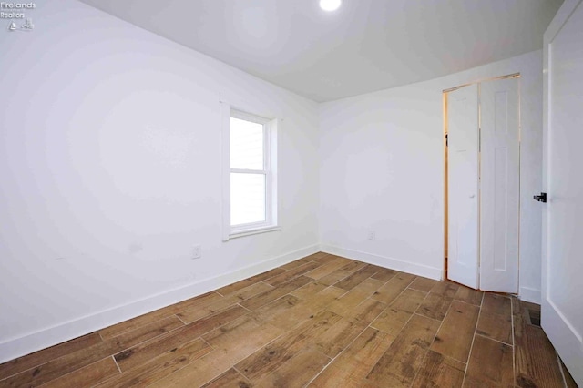 unfurnished bedroom featuring a closet and wood-type flooring