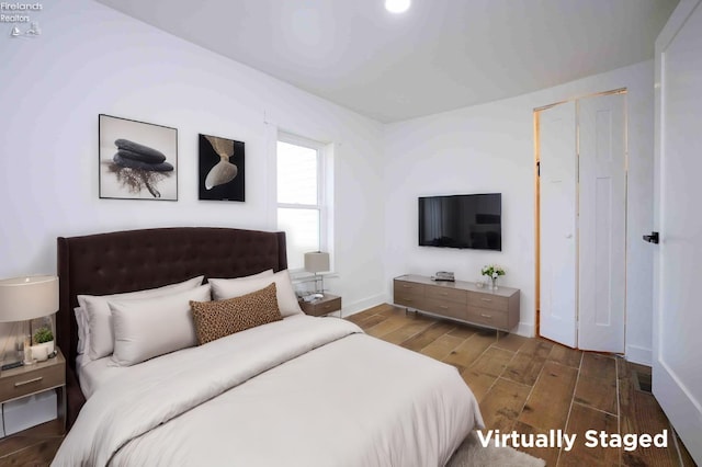 bedroom featuring a closet and dark hardwood / wood-style flooring