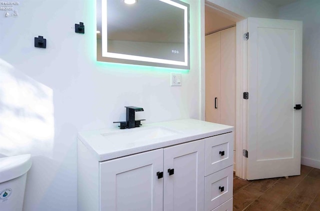 bathroom featuring toilet and vanity