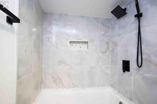 bathroom featuring tiled shower / bath