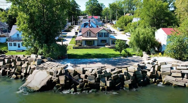 dock area with a yard and a water view