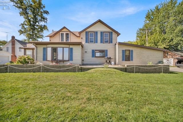 rear view of house with a lawn