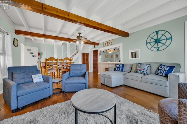 living room with dark wood-type flooring, ceiling fan, and beam ceiling