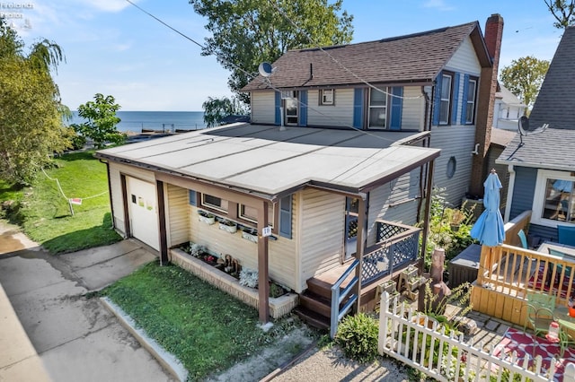 view of front of home featuring a garage and a deck with water view