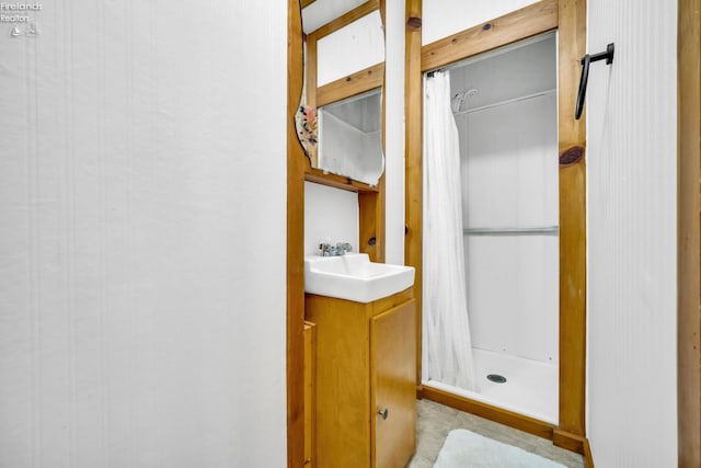 bathroom featuring walk in shower and vanity