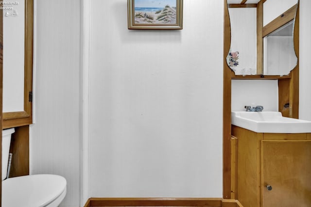 bathroom featuring toilet and vanity