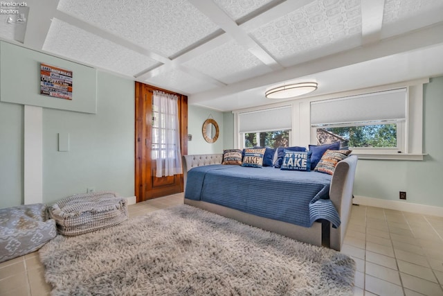 bedroom featuring coffered ceiling and light tile patterned flooring