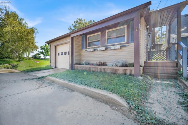 view of front of property with a garage and a front lawn