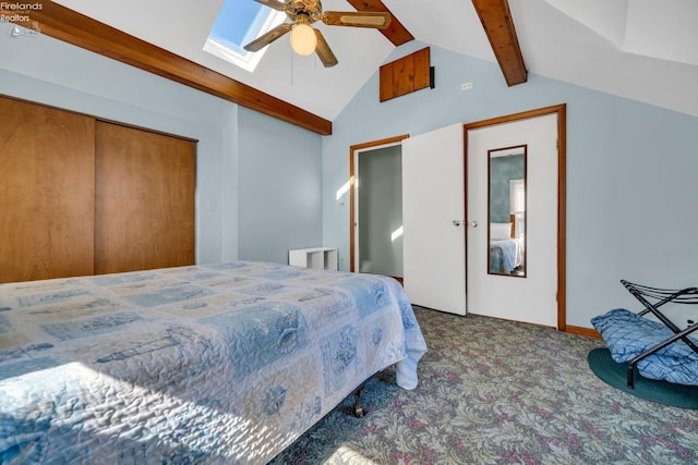 bedroom featuring carpet flooring, ceiling fan, a closet, and lofted ceiling with skylight