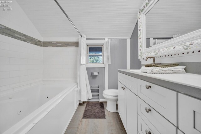 full bathroom featuring vanity, toilet, shower / tub combo with curtain, and wood-type flooring