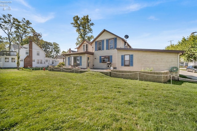 rear view of house with a yard