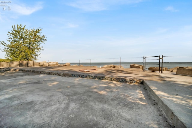 view of yard with an outdoor fire pit and a water view