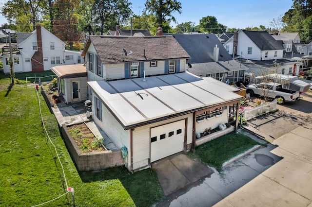 view of front of property with a garage and a front yard