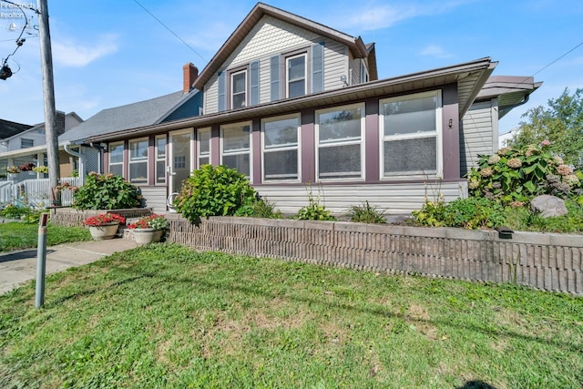 view of front of house featuring a front yard and a sunroom