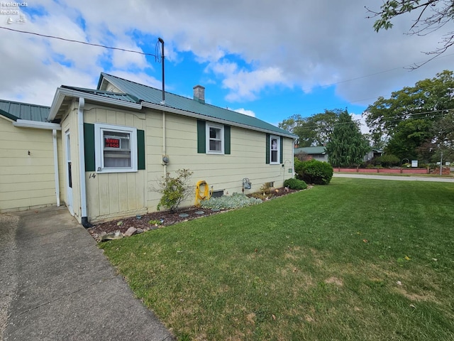 view of property exterior with a yard