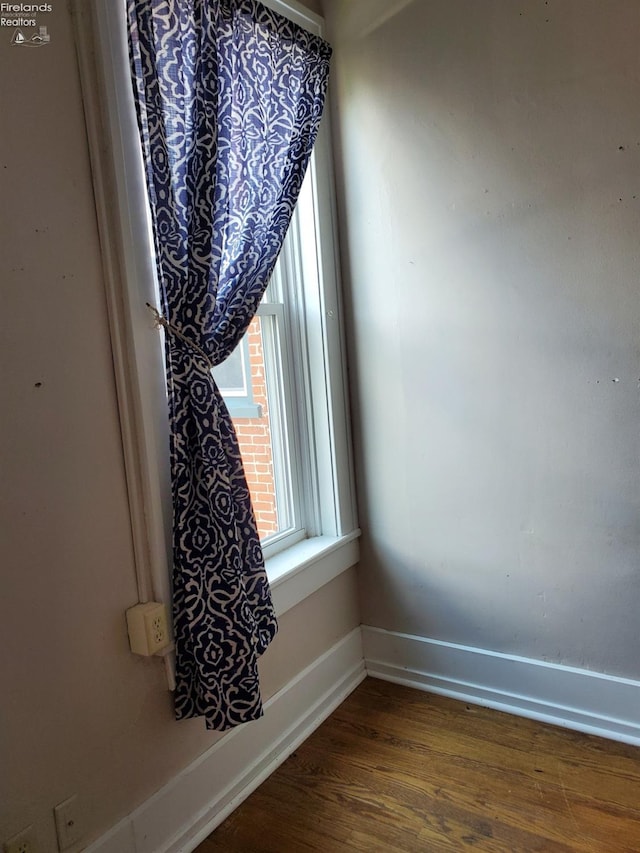 empty room featuring dark hardwood / wood-style flooring