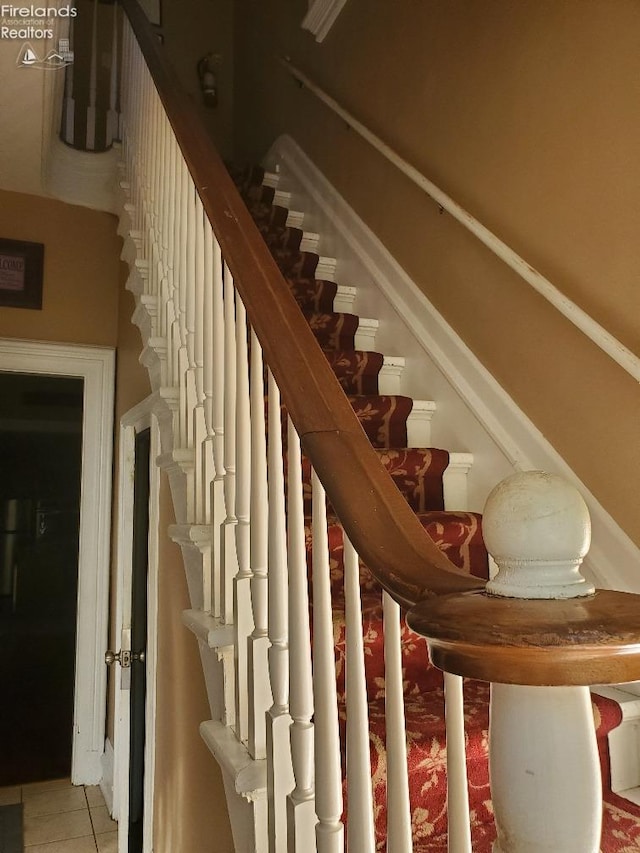 stairs with tile patterned flooring