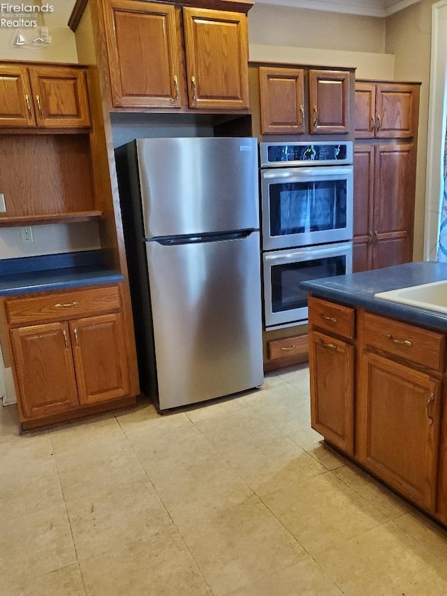 kitchen featuring ornamental molding and appliances with stainless steel finishes