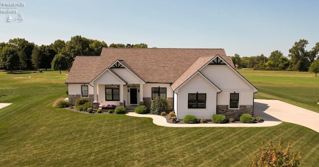 modern farmhouse with a front lawn and stone siding