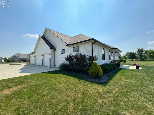 view of home's exterior with a lawn, driveway, an attached garage, and roof with shingles