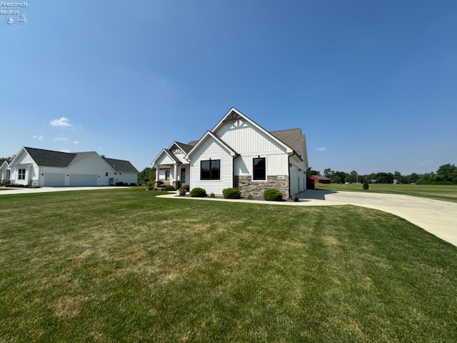 view of front facade with stone siding, board and batten siding, concrete driveway, and a front yard