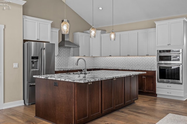 kitchen with lofted ceiling, white cabinets, dark wood-style floors, and appliances with stainless steel finishes