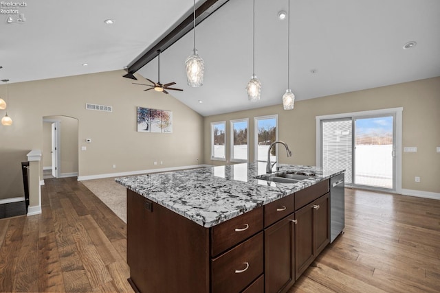 kitchen with open floor plan, dishwasher, wood finished floors, and a sink