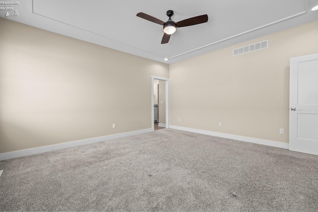 spare room featuring visible vents, baseboards, carpet, and ceiling fan