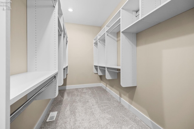 spacious closet with carpet and visible vents