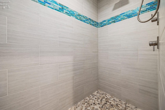 bathroom with a tile shower