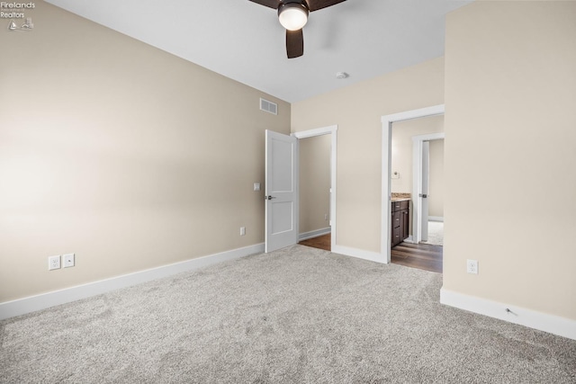 unfurnished bedroom featuring visible vents, ceiling fan, baseboards, and dark colored carpet